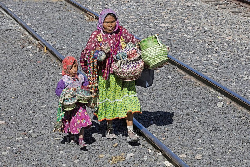 Mexican woman with child selling souvenirs to tourists on the tourist train of the Chepe Express