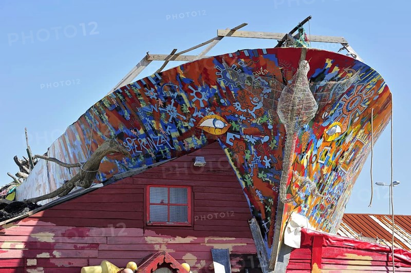 Decorated boat as work of art and artist's home in the harbour of L'Herbaudiere