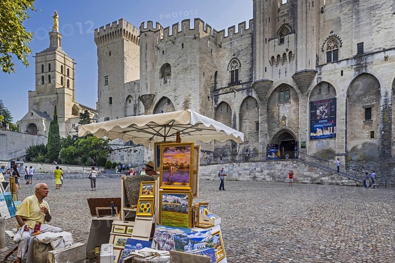 Artist selling paintings in front of the Palais des Papes