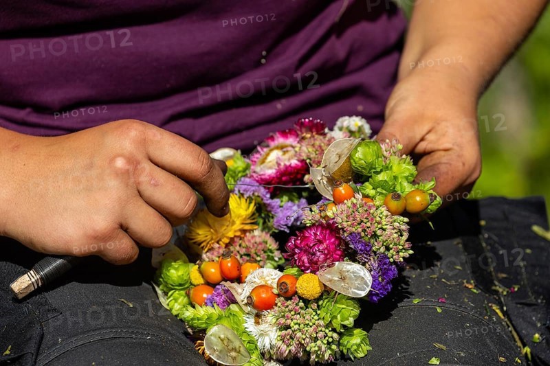 Florist weaving dried flower wreath
