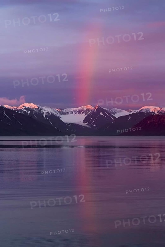 Rainbow over Liefdefjorden at sunset in summer