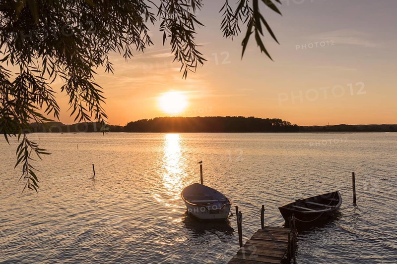 Wooden jetty with boats on Neustaedter Binnenwasser lake at Neustadt in Holstein