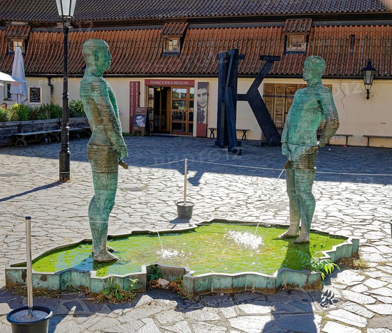 Two male figures peeing
