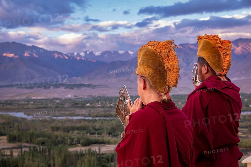 Monks blowing conches at Spituk Monastery