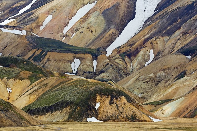 Sulphur coloured rhyolite mountains with patches of snow at Brennisteinsalda volcano near Landmannalaugar