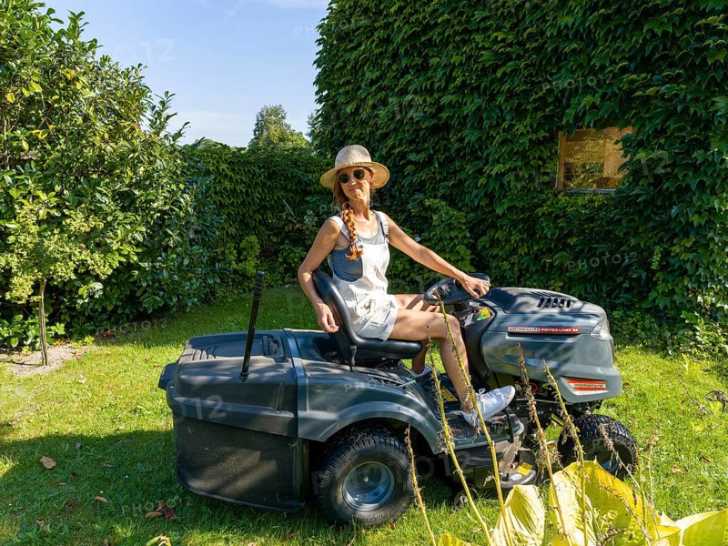 Woman driving lawn mower