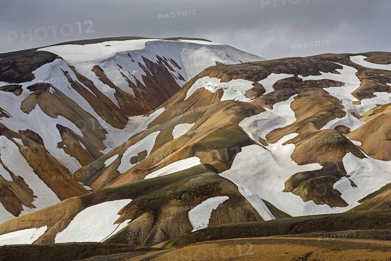 Sulphur coloured rhyolite mountains with patches of snow at Brennisteinsalda volcano near Landmannalaugar