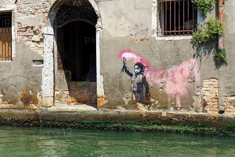Banksy graffito on a canal in the Dorsoduro district of Venice
