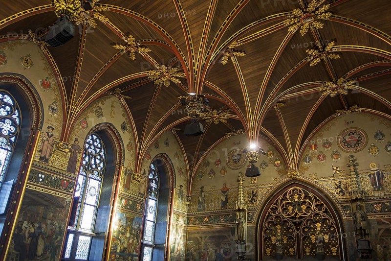 Interior of the city hall of Bruges showing the Gothic hall with polychrome vault and 19th century murals