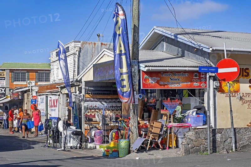 Streetscene showing local black people and shops at St. John's
