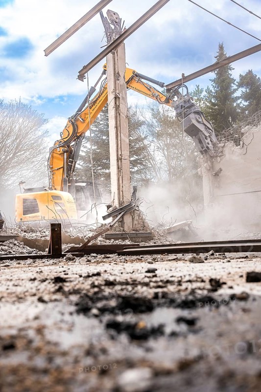Yellow Liebherr crawler excavator recycling on demolition site