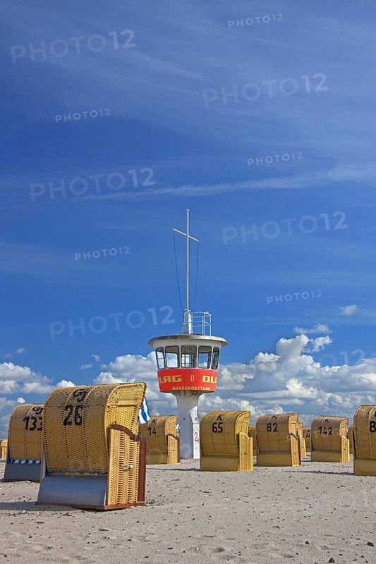 Lifeguard tower and roofed wicker beach chairs on the beach at Travemuende