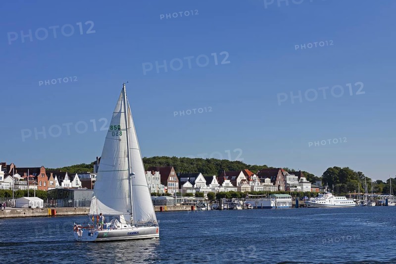 Sailing boat on the river Trave in front of Vorderreihe at Travemuende