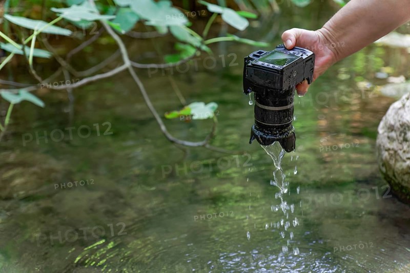 A reflex camera accidentally falls into the river