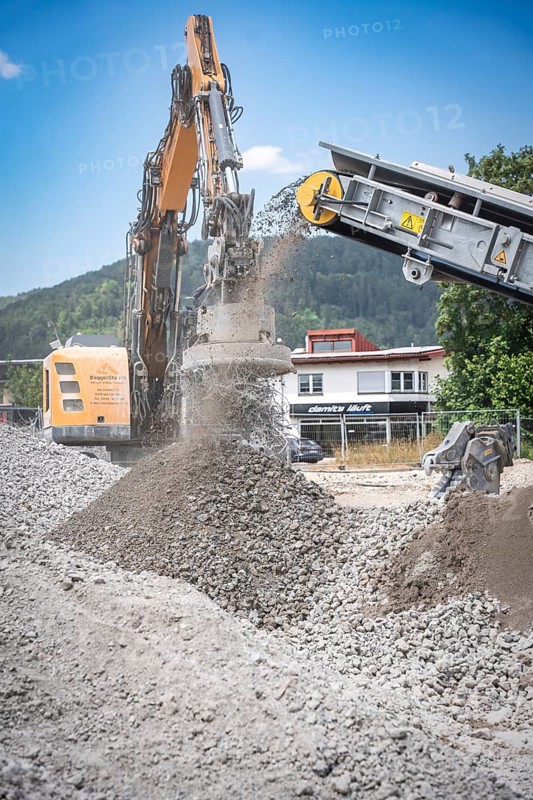 Yellow Liebherr crawler excavator recycling on demolition site
