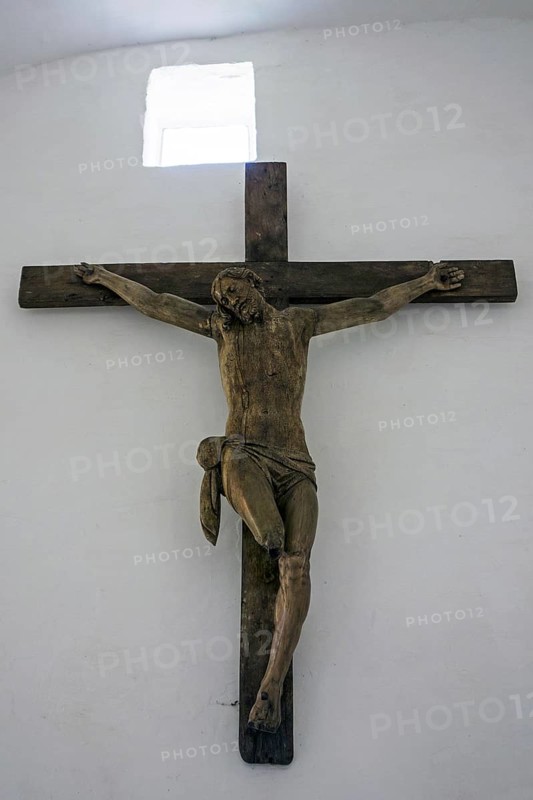 Large wooden crucifix of Christ with charred feet in the chapel of the Chateau d'Hougoumont