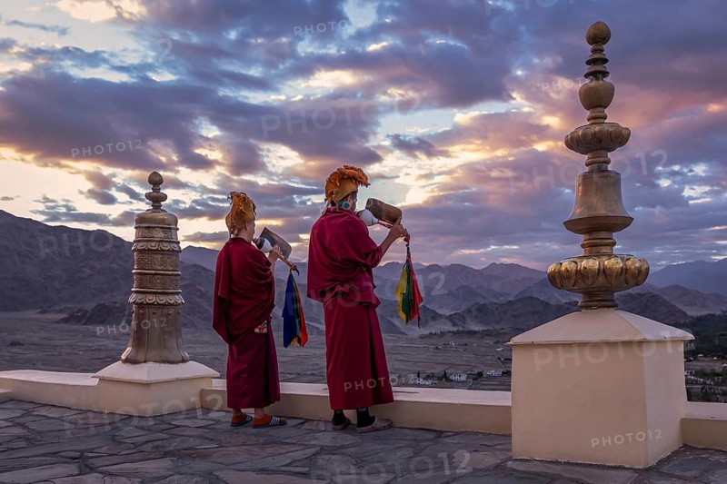 Monks blowing conches at Spituk Monastery