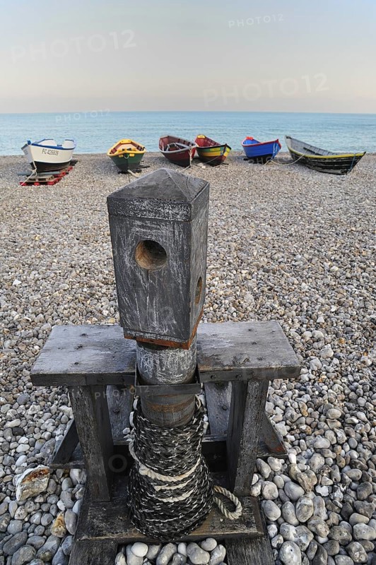 Old capstan and colourful traditional caiques