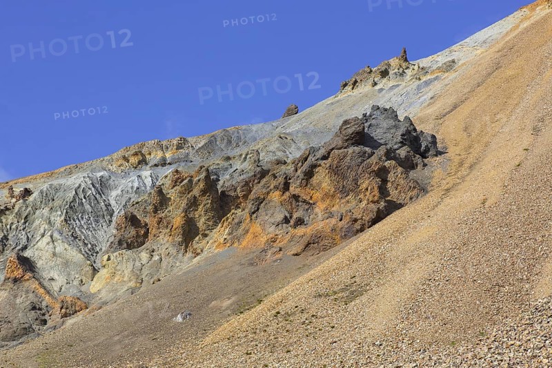 Volcanic rock formations and sulphur coloured rhyolite mountain at Brennisteinsalda volcano near Landmannalaugar