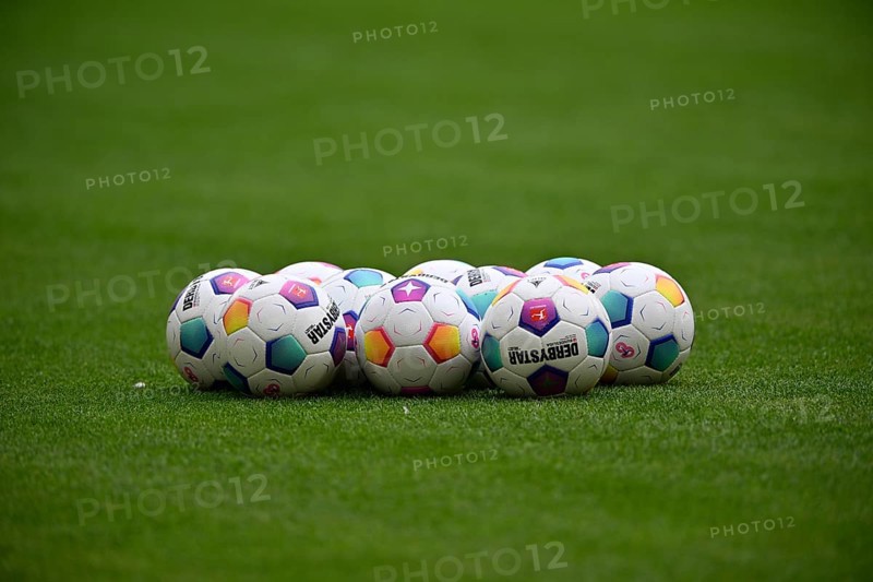 Adidas match balls Derbystar lie on grass