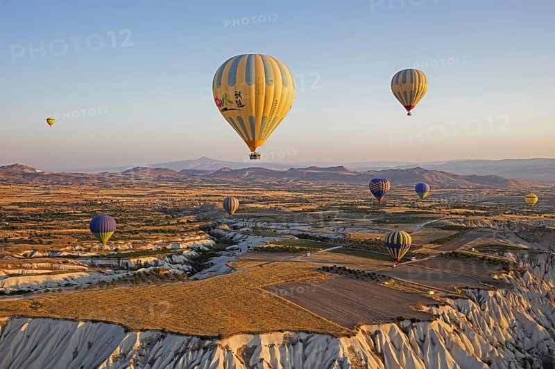 Hot air balloons flying over Cappadocia at sunrise