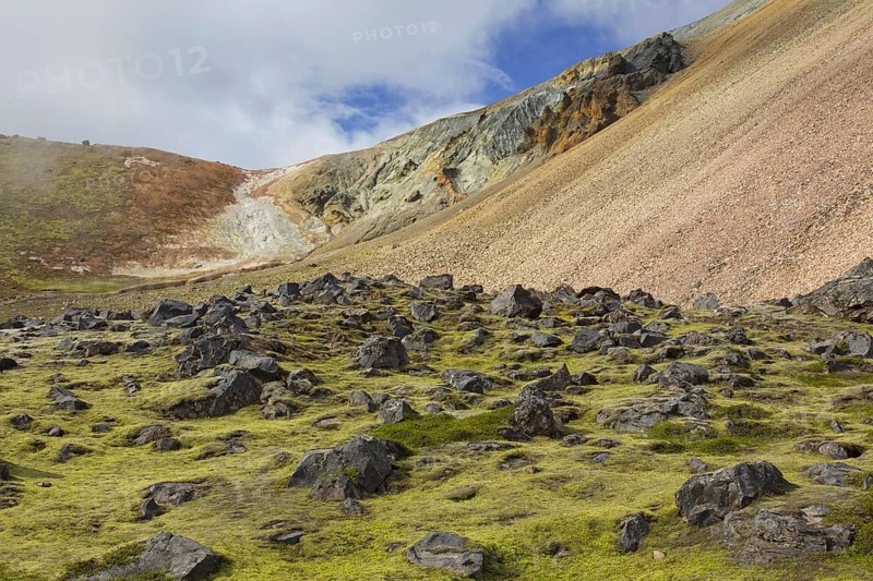 Lava field and sulphur coloured rhyolite mountains at Brennisteinsalda volcano near Landmannalaugar