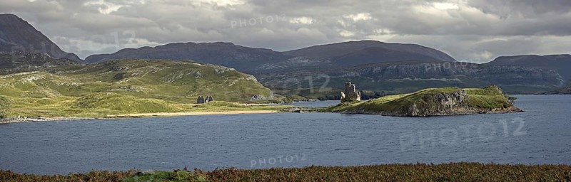 Calda House and the 16th century Ardvreck Castle ruins at Loch Assynt in the Highlands at sunset