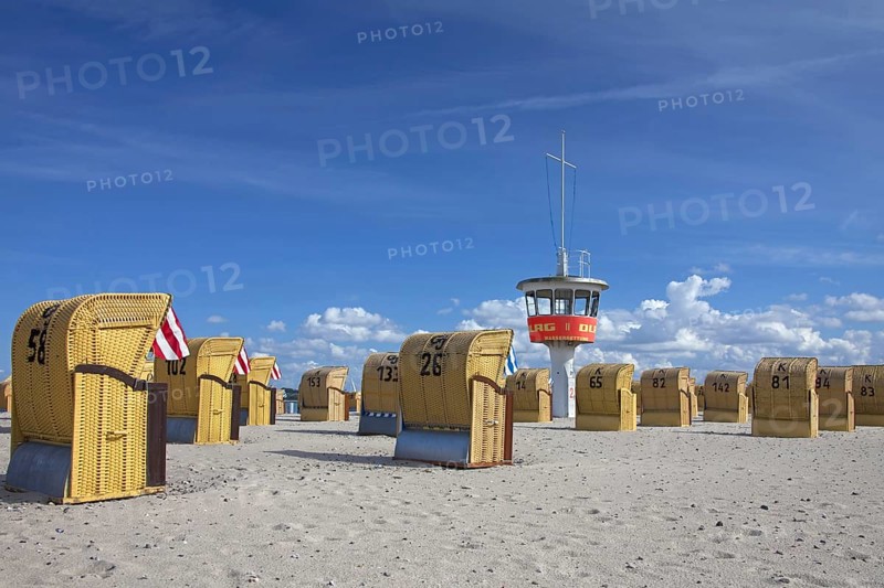 Lifeguard tower and roofed wicker beach chairs on the beach at Travemuende
