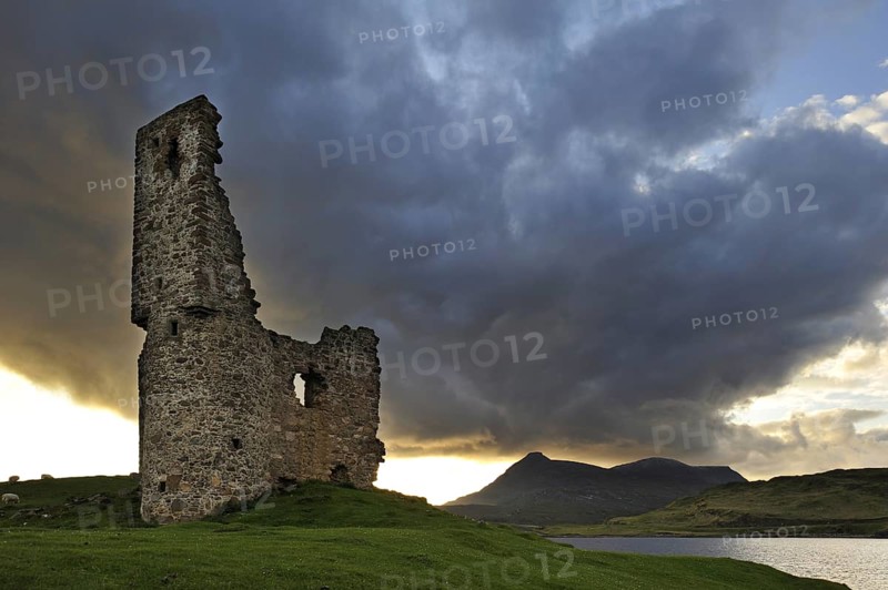 The 16th century Ardvreck Castle ruins at Loch Assynt in the Highlands at sunset