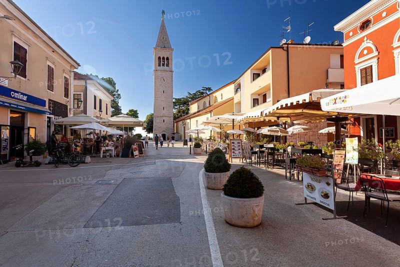 Belltower and terraces of restaurants in the historic town centre of Novigrad