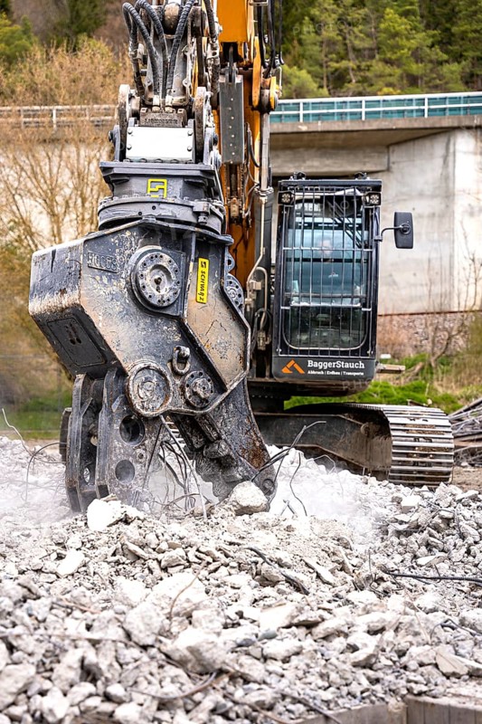 Yellow Liebherr crawler excavator recycling on demolition site