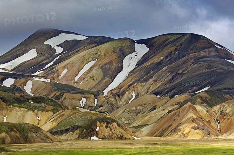Sulphur coloured rhyolite mountains with patches of snow at Brennisteinsalda volcano near Landmannalaugar