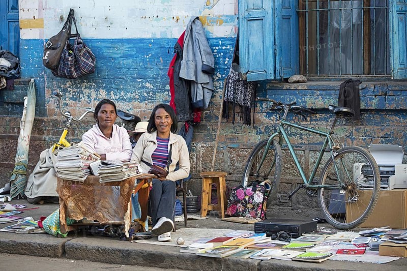 Malagasy women selling books and newspapers in the streets of the city Antsirabe