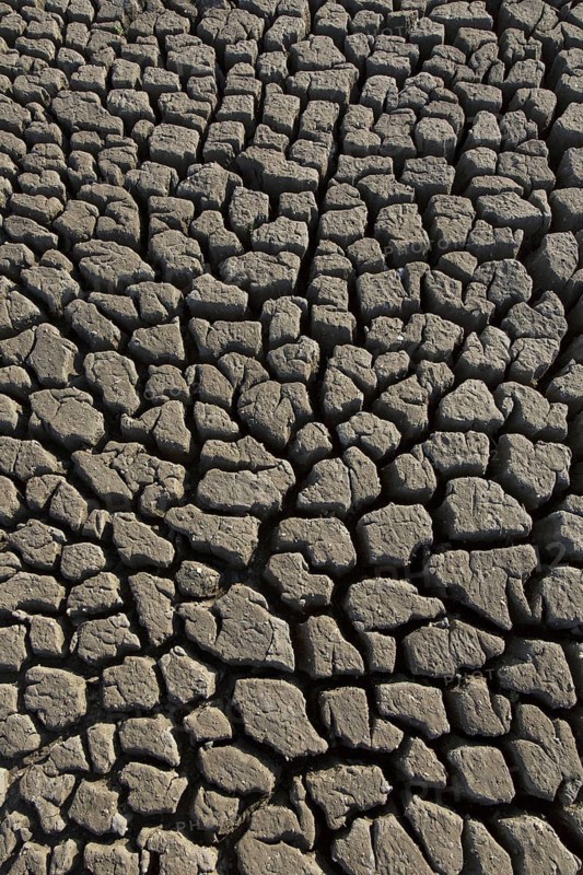 Abstract pattern of dry cracked clay mud in dried up lake bed