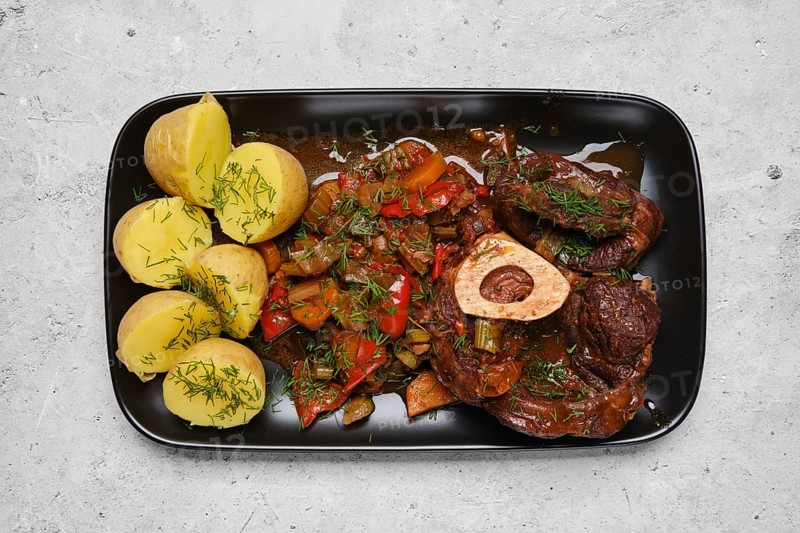 Top view of beef ossobuco and vegetable ragout in a plate