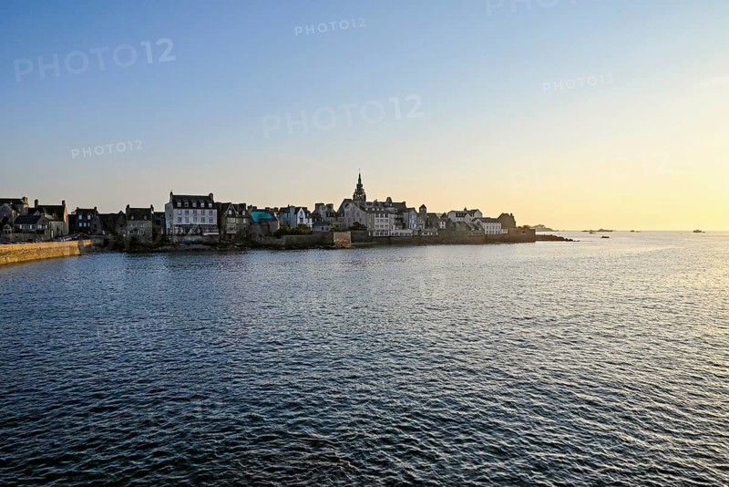 Old town with buildings and church tower by the sea