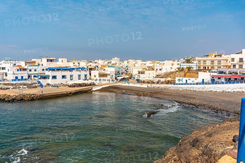 View from above of the black beach of the tourist town of El Cotillo in the north of the island of Fuerteventura