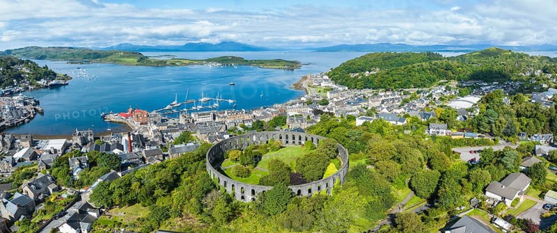 Aerial panorama of the harbour town of Oban with McCaig's Tower
