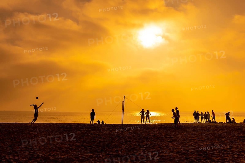 Some young people playing volleyball on the beach of San Miguel in the city of Almeria