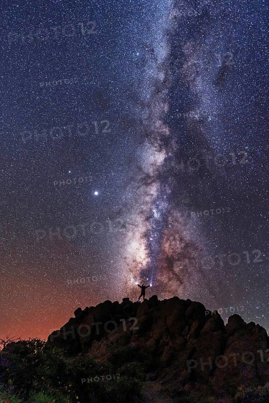 A young woman below the beautiful lactea way of the Caldera de Taburiente near the Roque de los Muchahos on the island of La Palma