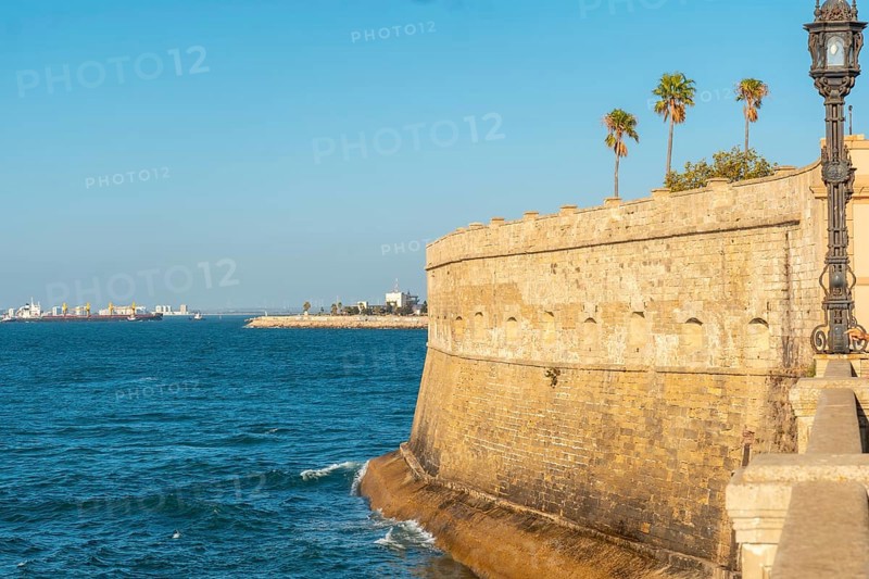 Walls and sea coast of the Baluarte de la Candelaria in the city of Cadiz. Andalusia