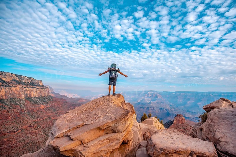 A young man on a viewpoint of the descent of the South Kaibab Trailhead. Grand Canyon