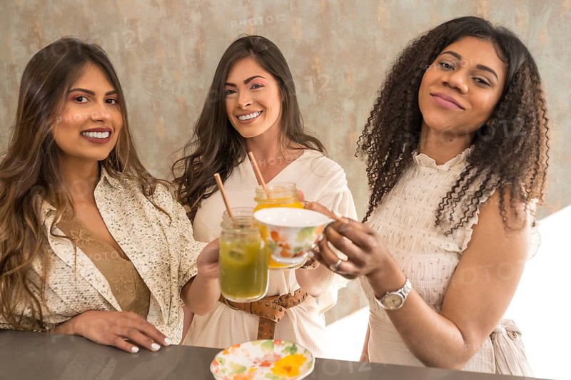 Woman toasting and celebrating with juices and tea