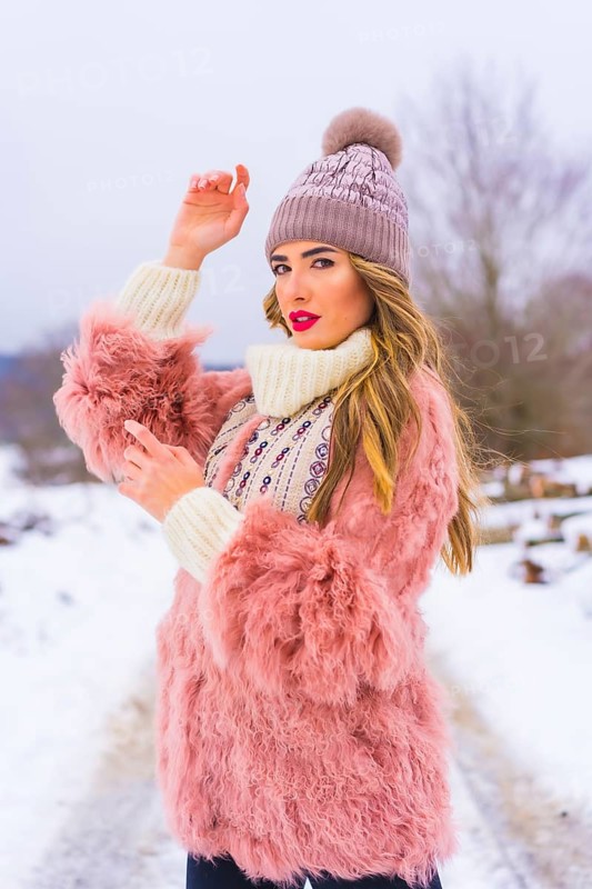 Portrait of young blonde model wearing pink fur jacket