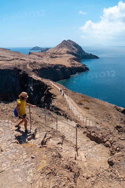 A young woman in Sao Lourenco going down the stairs of the trekking trail
