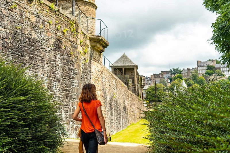 A young tourist visiting the castle of Fougeres. Brittany region