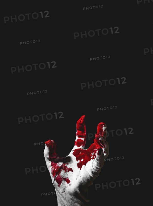 Reaching up hand in white glove with blood stains