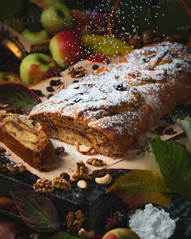 Dusting sugar falls on nut strudel in autumn atmosphere