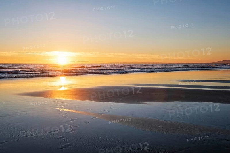 Atlantic ocean sunset with surging waves at Fonte da Telha beach