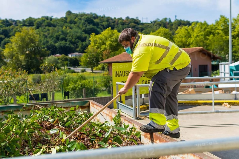 Worker in a recycling factory or clean point and garbage with a face mask and with security protections